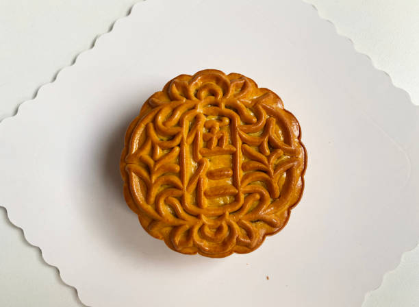istock traditional gourmet home made baked moon cake mixed nuts lotus paste egg yolk red bean filling on white background for Chinese mid autumn festival celebration dessert pastry menu halal food in asian 2062429712