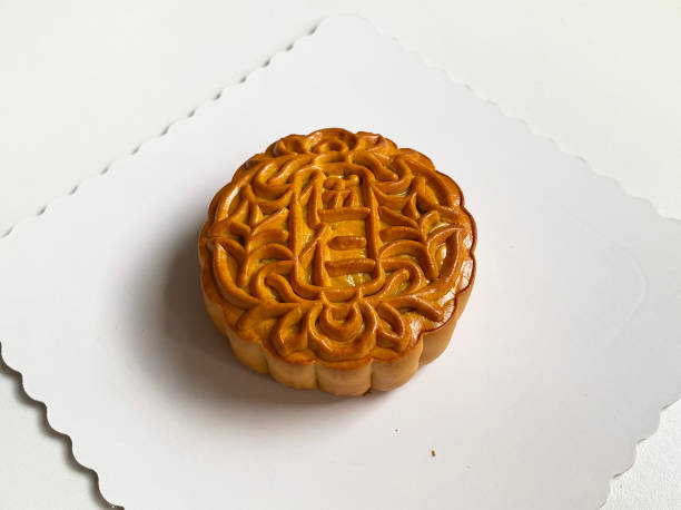 istock traditional gourmet home made baked moon cake mixed nuts lotus paste egg yolk red bean filling on white background for Chinese mid autumn festival celebration dessert pastry menu halal food in asian 2062429720