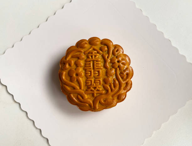 istock traditional gourmet home made baked moon cake mixed nuts lotus paste egg yolk red bean filling on white background for Chinese mid autumn festival celebration dessert pastry menu halal food in asian 2062431338