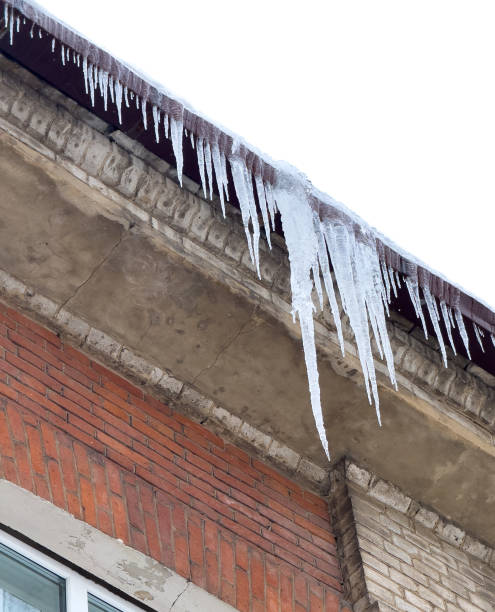 istock Icicles hang from the brick wall of the building 2062442728