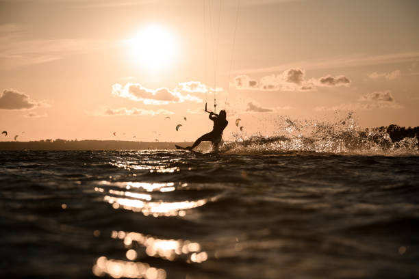 istock Female wakeboarder rides a wakeboard, holding on to a comfortable handle on a cable 2062453176