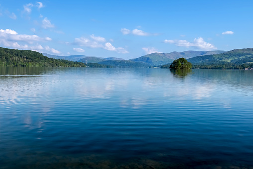 Lake Windermere looking north towards Waterhead and Ambleside in the English Lake District with  a number of fells in the background.