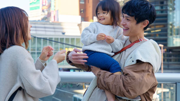 istock Two Young Japanese Parents Playing with Toddler Daughter 2062463829