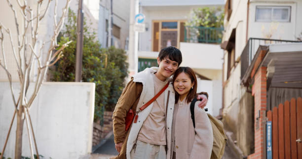 istock Young Japanese Couple Standing and Smiling Together 2062465450