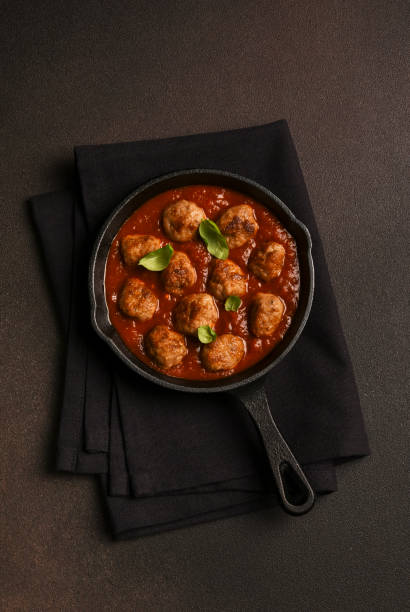 istock Meatballs with tomato sauce and basil in a frying pan 2062470224