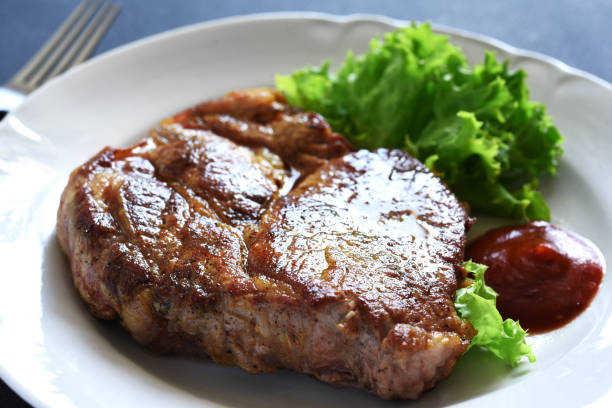 istock Grilled pork steak with tomato sauce and salad 2062471858