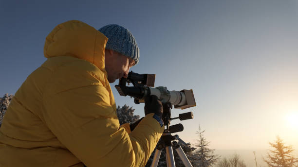 istock Amateur astronomer looking at the Sun through a telescope with special solar filter. 2062471859