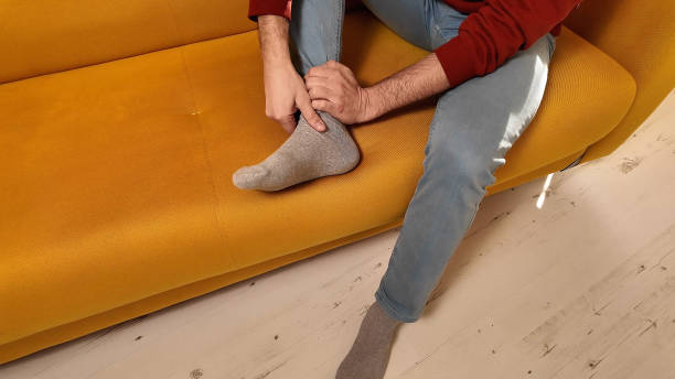 istock Man with ankle and foot pain at home. 2062473965