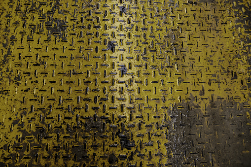 Detail of yellow non-slip rough metal floor