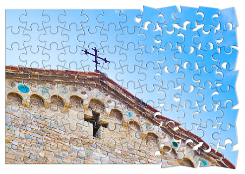 Christian cross of a medieval italian church - The slow growth in faith - concept in jigsaw puzzle shape