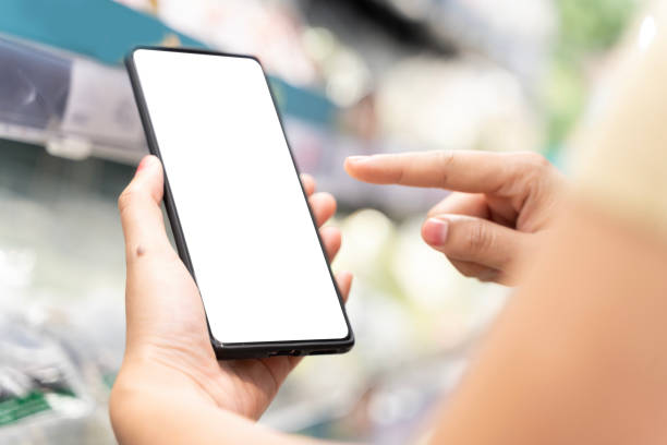 istock A woman's hand is holding a mobile phone, clipping path. The mobile phone screen is blank Looks lost or thinking. 2062509861