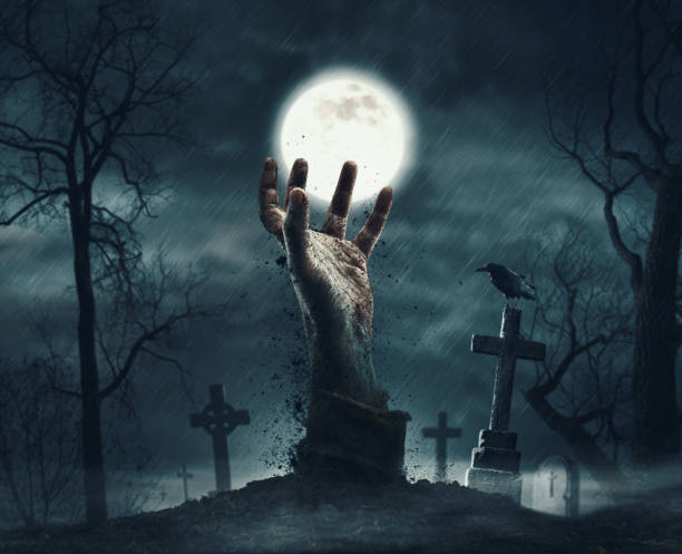 istock Zombie rising from the grave in the cemetery 2062521427