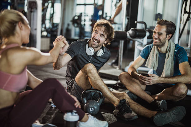 istock Happy athletic friends talking on a break in a gym. 2062537977