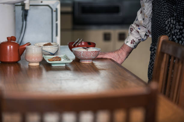 Elderly japanese woman eating lonely