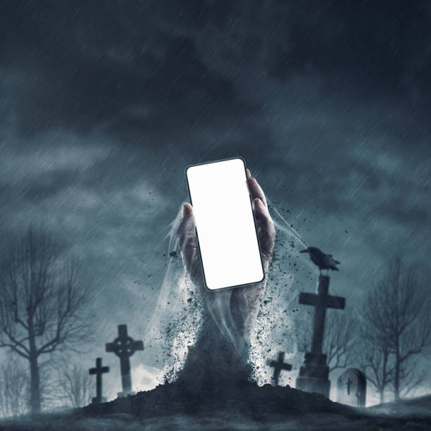 istock Zombie holding a smartphone in the graveyard 2062544820