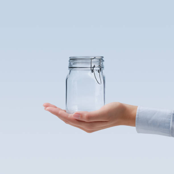 istock Female hand holding an empty glass jar 2062548959