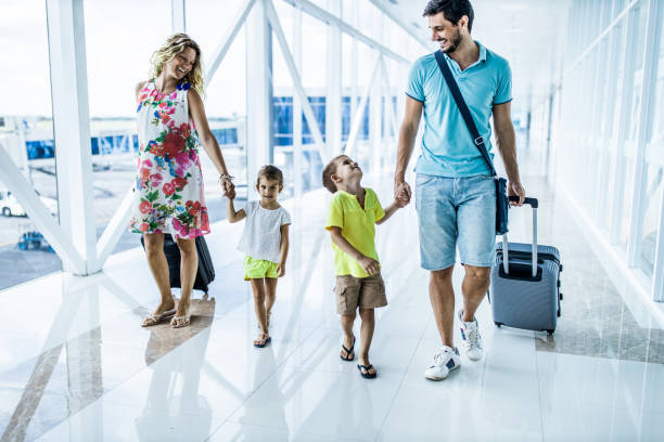 istock Happy family talking while walking through airport hallway. 2062550011