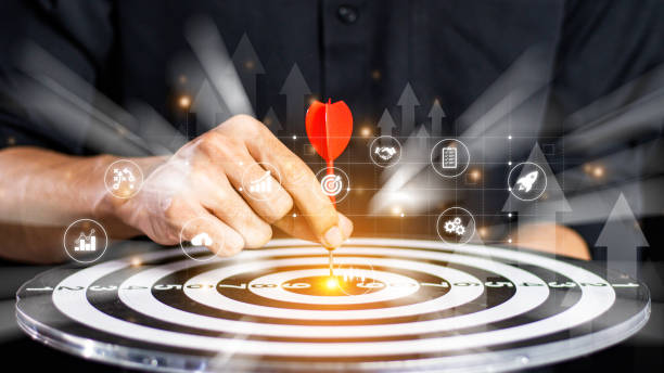 istock Businessman throwing red arrow dart to  target dart board. Setup objectives and target for business investment concept. business investment objective concept Marketing strategies and goals for success 2062550556