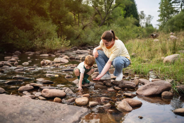 istock Mom and son playing on the shallow mountain river 2062560821