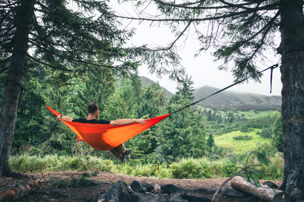istock man in hammock at camping site mountains on background 2062560831