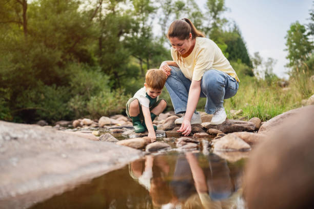 istock Mom and son playing on the shallow mountain river 2062561088