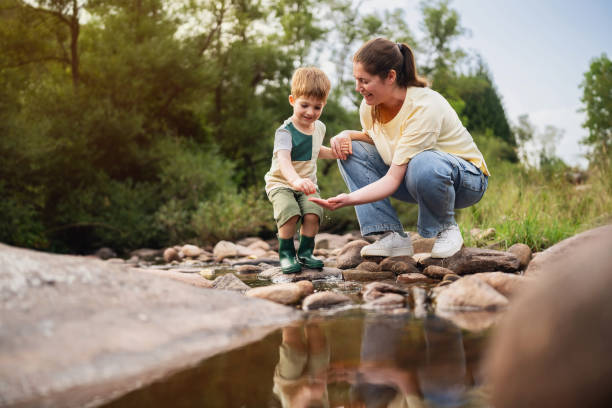 istock Mom and son playing on the shallow mountain river 2062561346