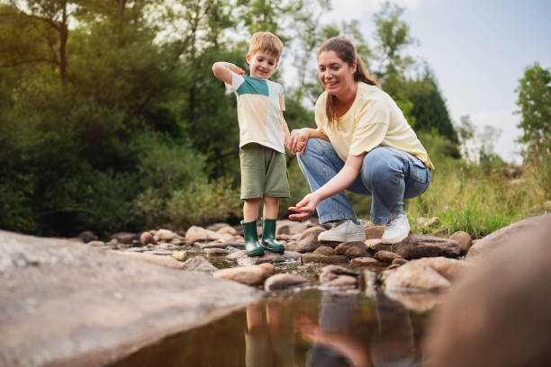 istock Mom and son playing on the shallow mountain river 2062561389
