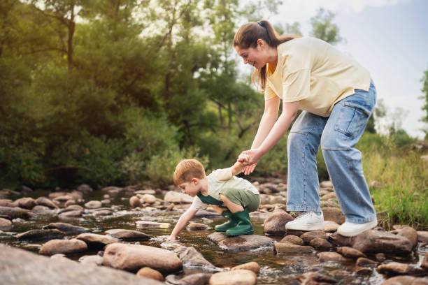 istock Mom and son playing on the shallow mountain river 2062561390