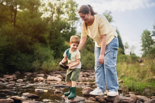 istock Mom and son playing on the shallow mountain river 2062561391