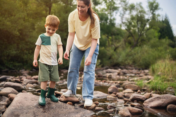 istock Mom and son playing on the shallow mountain river 2062561950