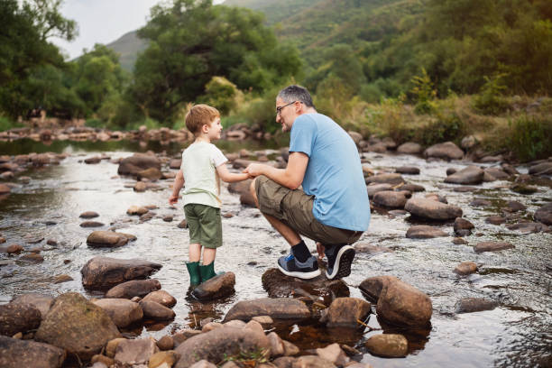 istock Father and son enjoying a carefree spring day in nature 2062562529