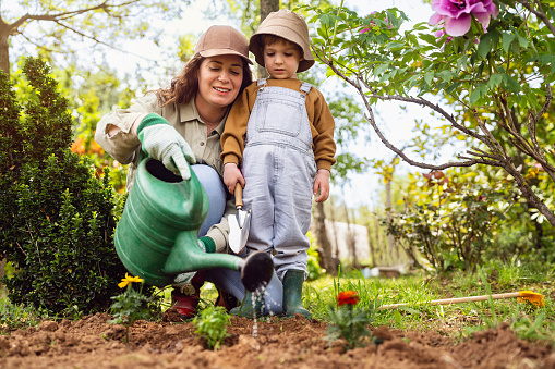 Mother and son gardening together.