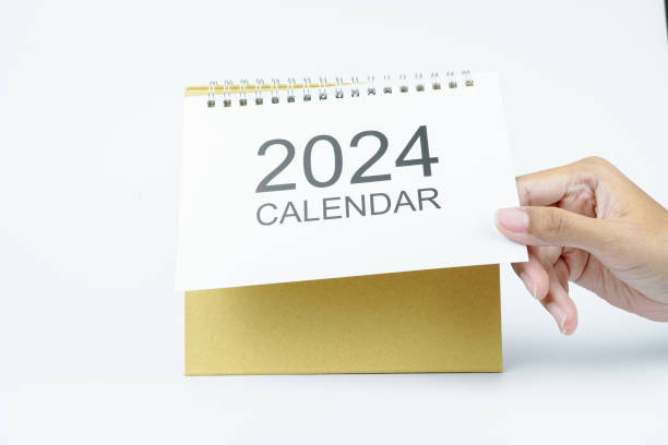 istock woman hand open 2024 calendar on white background 2062569502