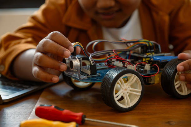 istock Little African boy doing robot  project in science classroom. 2062584050