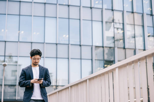istock Young Japanese professional stays connected with his smartphone 2062596866