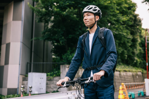 istock Japanese professional walks casually with his bike 2062597400