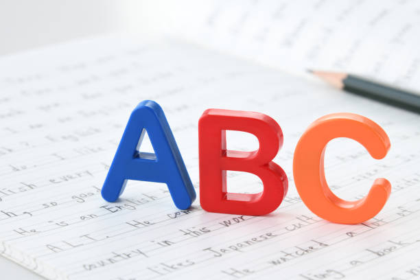 Toy alphabet blocks on English notebook