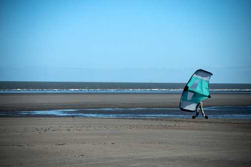 portrait of man using wind surf board  on the beach