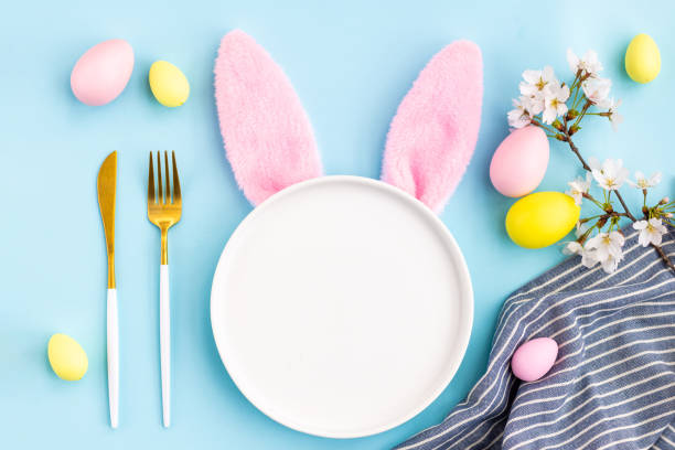 istock Stylish background with colorful easter eggs isolated on blue background with white blooming sakura branch. Flat lay, top view, mockup with copy space, overhead, template 2062620107