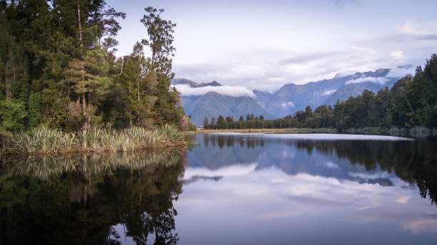 istock Beautiful lake surrounded by exotic forest and mountains in background during sunset, New Zealand 2062630865