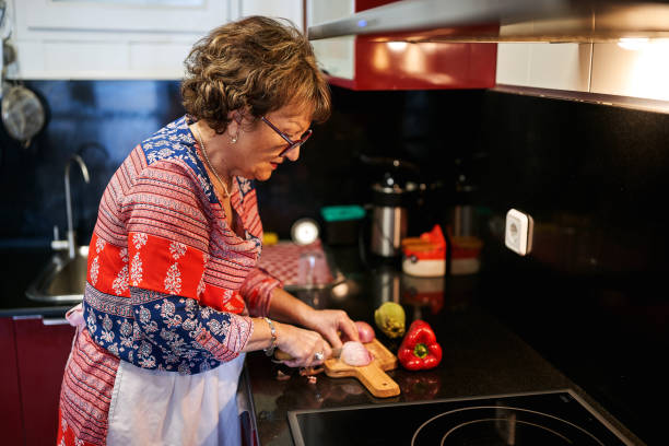 istock Senior woman preparing dinner at home kitchen. 2062659040
