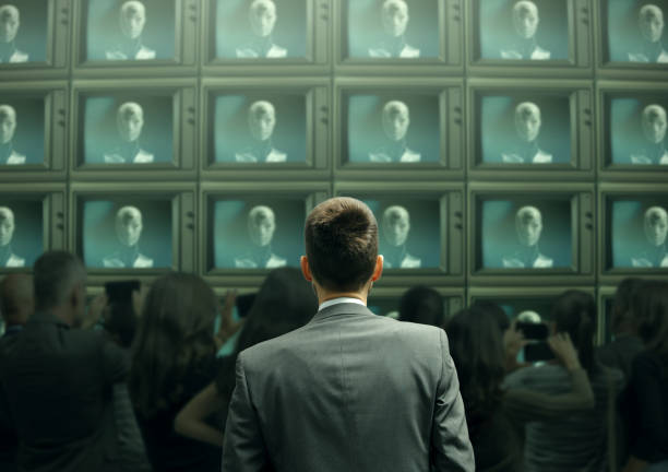 Humanoid AI robot broadcast on all TV channels and man staring at the screens