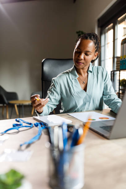 istock Diligent woman working at her desk in a small office 2062670693