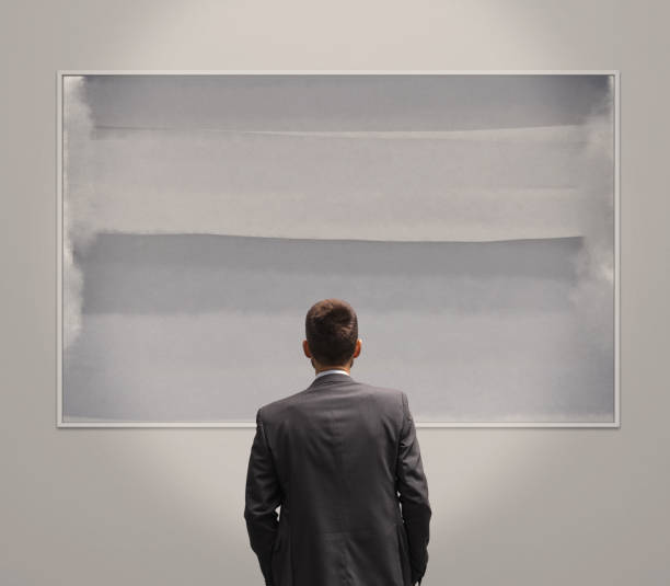 istock Man looking at paintings at the art exhibition 2062675457