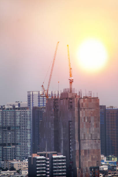 istock about a twin tower crane at the construction building working through sunset 2062683948