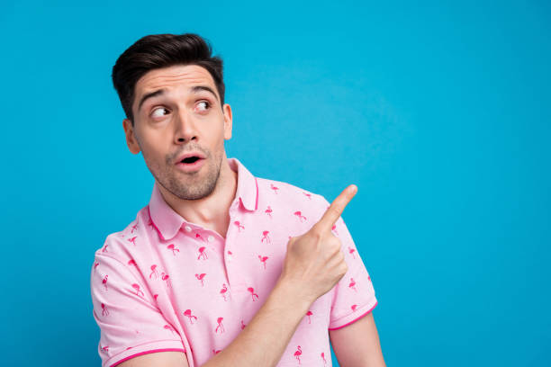 istock Portrait of speechless impressed young man open mouth indicate finger empty space isolated on blue color background 2062694050