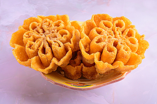 A closeup of flower-shaped pastries on a plate