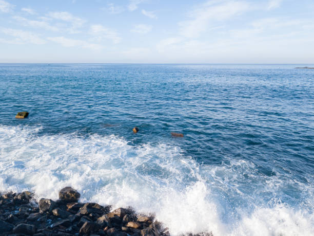 The natural wonder of El Bufadero is located in the municipality of Telde (in the east of Gran Canaria), on the seafront promenade that connects the districts of Hoya del Pozo and La Garita. It is a cave formed in the rocks on the seashore, with a hole in the roof as a skylight. When the waves enter and cover the opening, compressed air escapes through the hole in the roof, creating a tremendous \