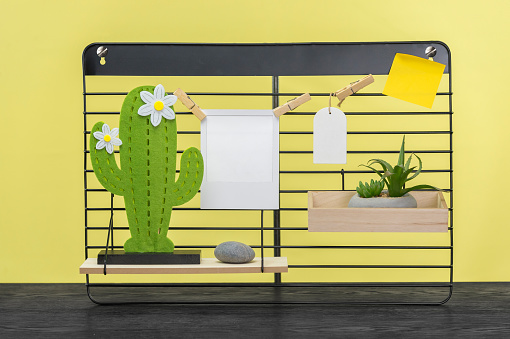 A 3D illustration of a black shelf with a cactus with copyspace