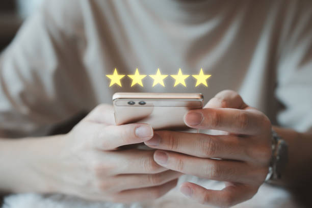 istock Customer is using a mobile smartphone to giving a 5 star satisfaction score for a positive experience. 2062718055